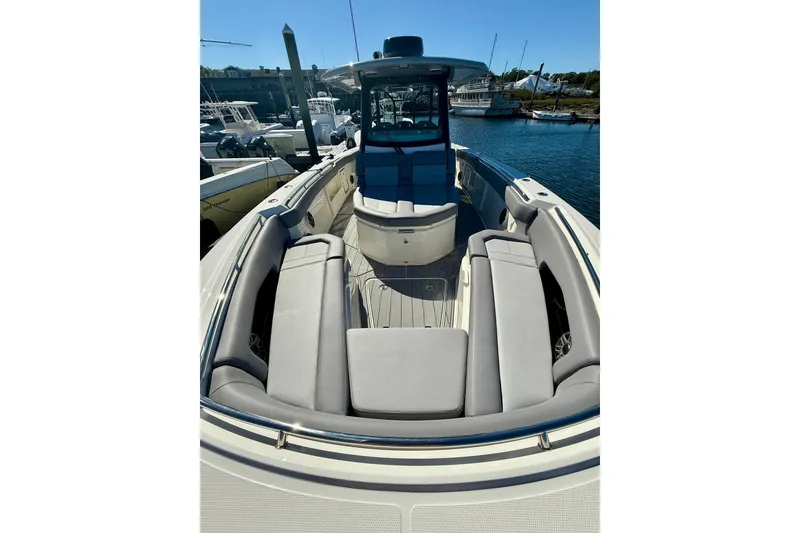 Slide: The Image of 2024 Boston Whaler 360 Outrage boat with spacious seating at the dock. - 25