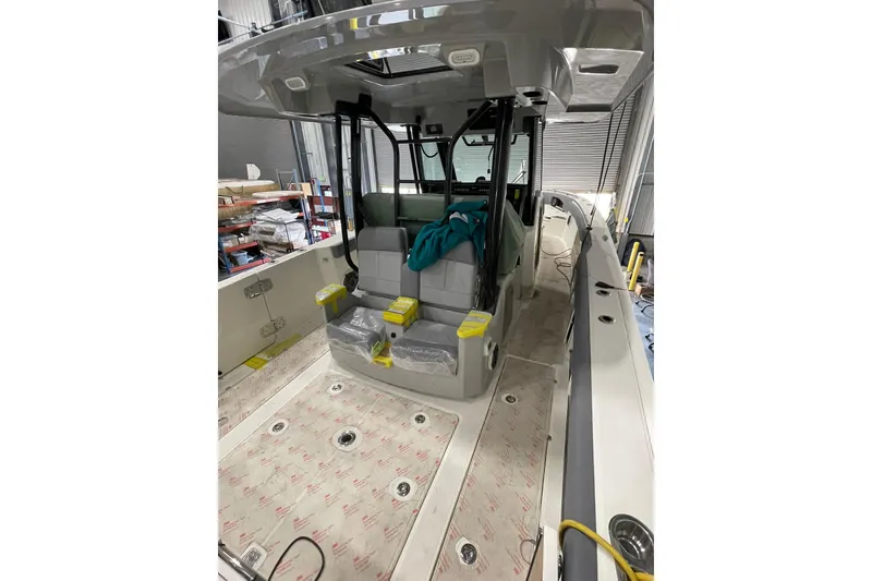Slide: The Image of 2024 Boston Whaler 360 Outrage boat interior with seating and storage areas. - 67