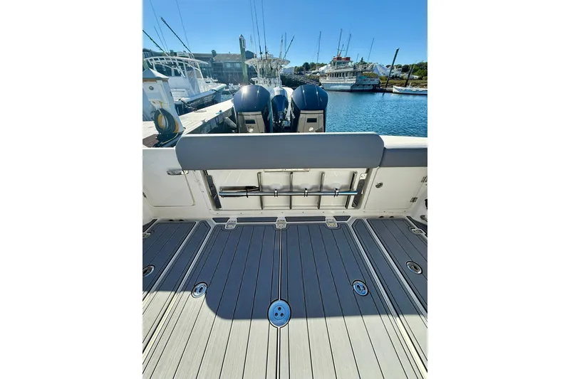 Slide: The Image of 2024 Boston Whaler 360 Outrage boat deck with dual engines at marina. - 34