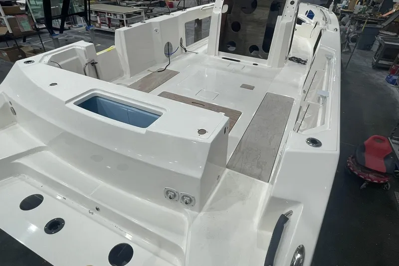 Slide: The Image of 2024 Boston Whaler 360 Outrage boat interior under construction in a workshop. - 49