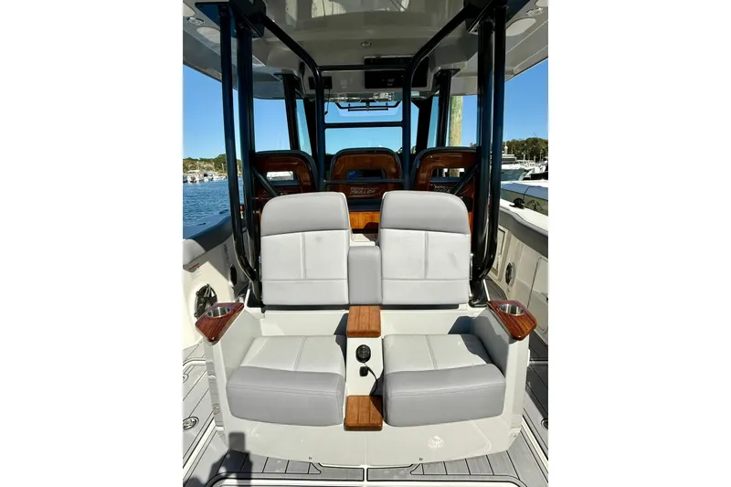 Slide: The Image of 2024 Boston Whaler 360 Outrage interior with luxurious seating and sleek design. - 16