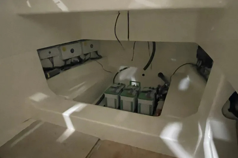 Slide: The Image of 2024 Boston Whaler 360 Outrage battery compartment with wiring and equipment. - 59