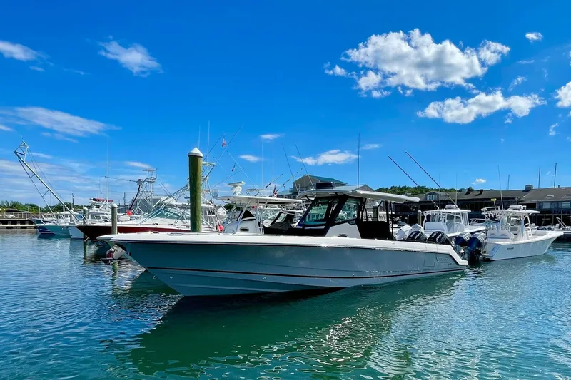 Slide: The Image of 2024 Boston Whaler 360 Outrage docked in a sunny marina. - 3