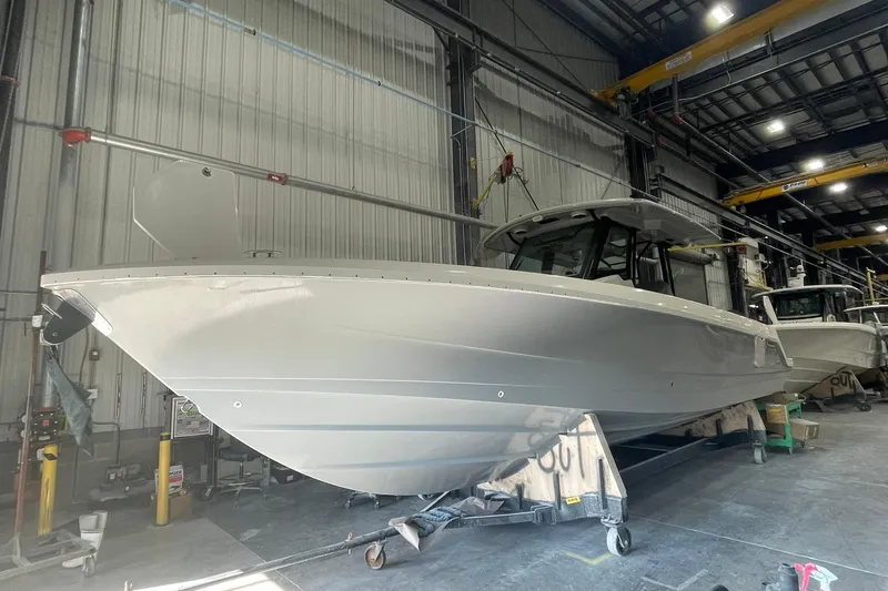 Slide: The Image of 2024 Boston Whaler 360 Outrage boat in a warehouse setting. - 65