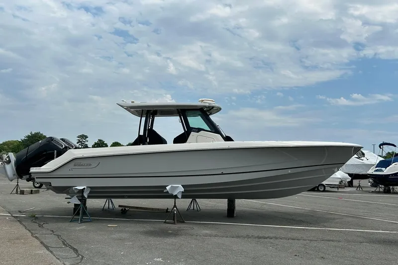 Slide: The Image of 2024 Boston Whaler 360 Outrage boat on display under cloudy sky. - 87