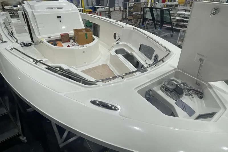 Slide: The Image of 2024 Boston Whaler 360 Outrage boat interior under construction in a workshop. - 50