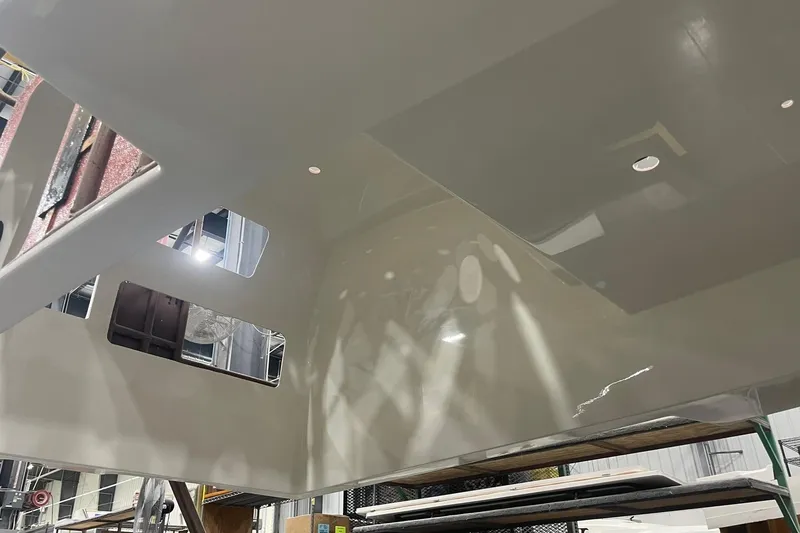 Slide: The Image of 2024 Boston Whaler 360 Outrage under construction, showcasing interior framework details. - 52