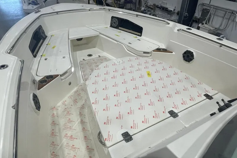Slide: The Image of 2024 Boston Whaler 360 Outrage boat interior with seating and storage compartments. - 58