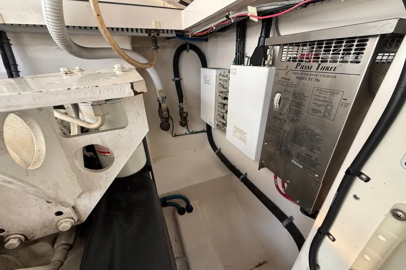 Slide: The Image of Engine compartment of a 2007 Cabo 32 Express boat, featuring electrical components and wiring. - 38