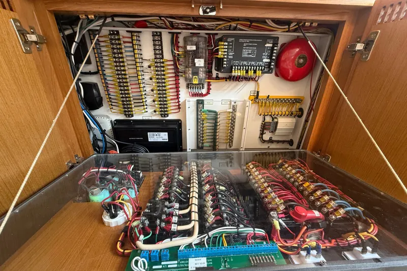 Slide: The Image of Electrical panel inside a 2007 Cabo 32 Express boat, showcasing wiring and components. - 72