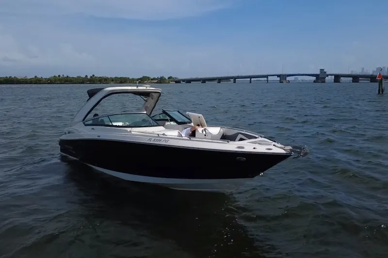 Slide: The Image of 2011 Monterey 328SS Super Sport boat on water near a bridge under blue sky. - 9