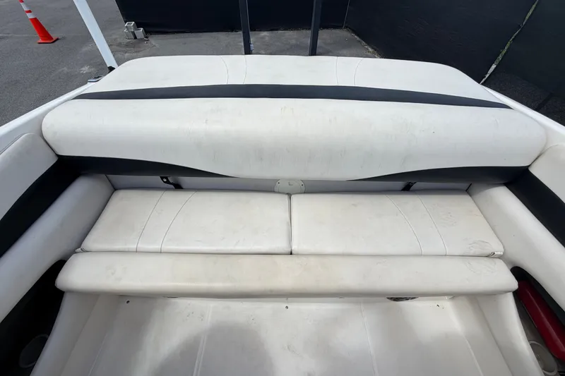 Slide: The Image of 2003 Chaparral 183 SS boat interior seating, featuring white and black upholstery. - 50