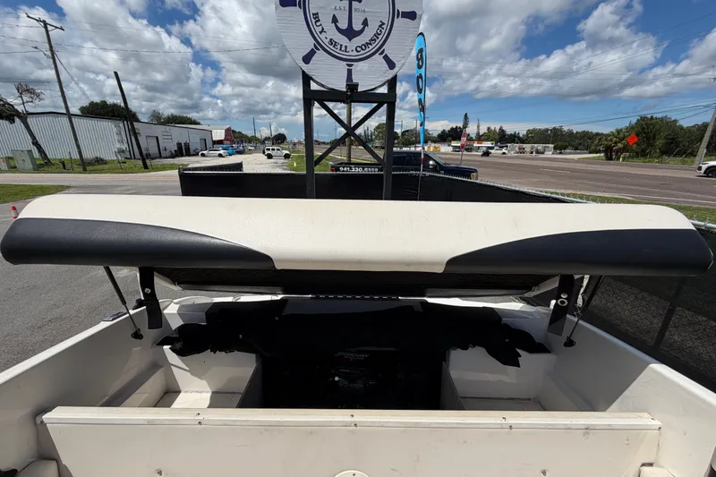 Slide: The Image of 2003 Chaparral 183 SS boat interior with engine compartment, parked outdoors under cloudy sky. - 53