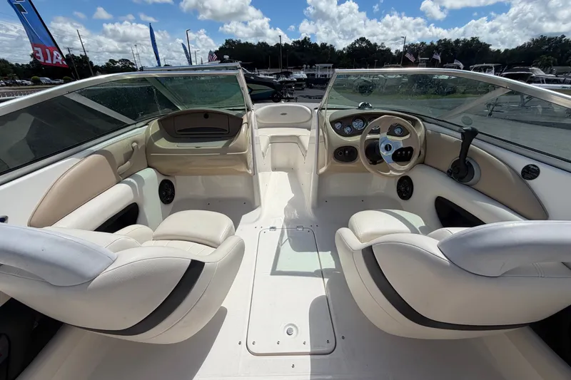 Slide: The Image of Interior view of a 2003 Chaparral 183 SS boat with beige seating and dashboard. - 14