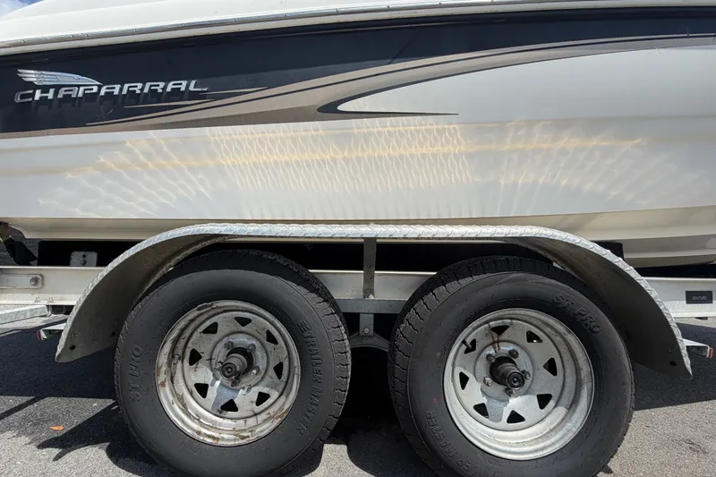 Slide: The Image of 2003 Chaparral 183 SS boat on trailer, showcasing side view and wheels. - 69