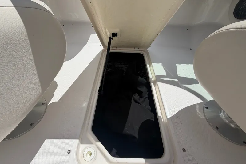 Slide: The Image of Un compartiment de rangement ouvert dans le sol d'un bateau avec des sièges blancs. - 16
