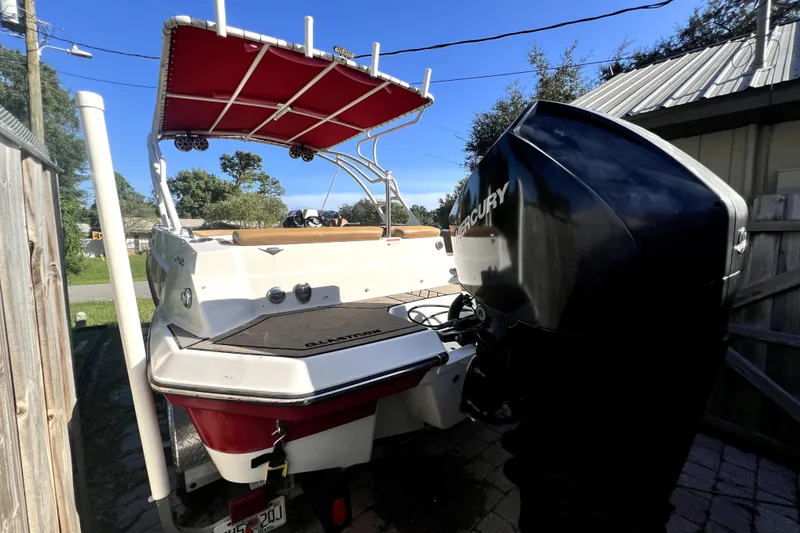 Slide: The Image of 2019 Glastron GTD 220 boat with Mercury outboard motor, parked outdoors. - 14