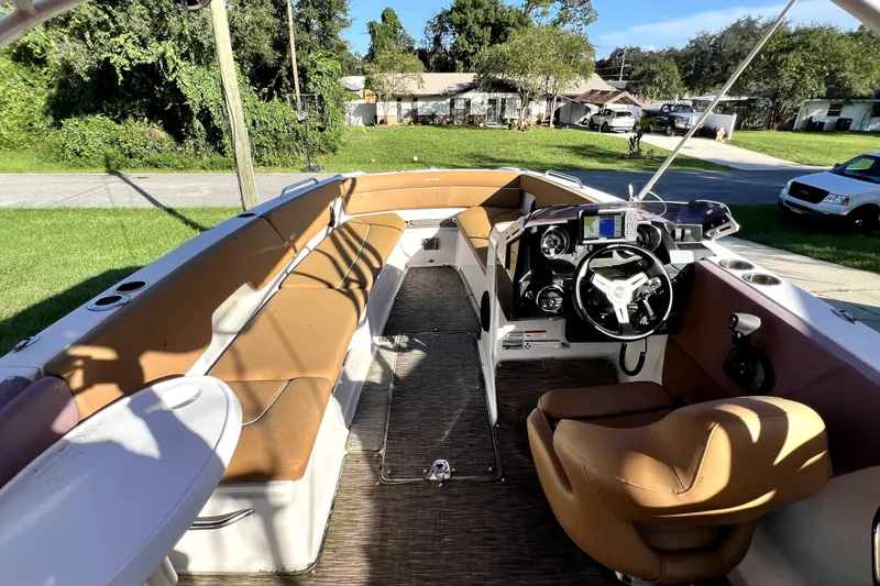 Slide: The Image of 2019 Glastron GTD 220 boat interior with tan seating and modern dashboard. - 28