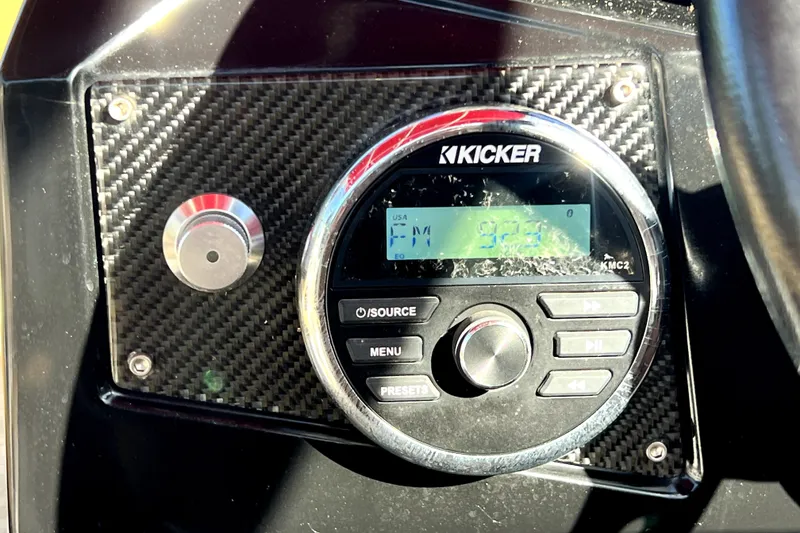 Slide: The Image of Kicker stereo system on 2019 Glastron GTD 220 boat dashboard. - 62