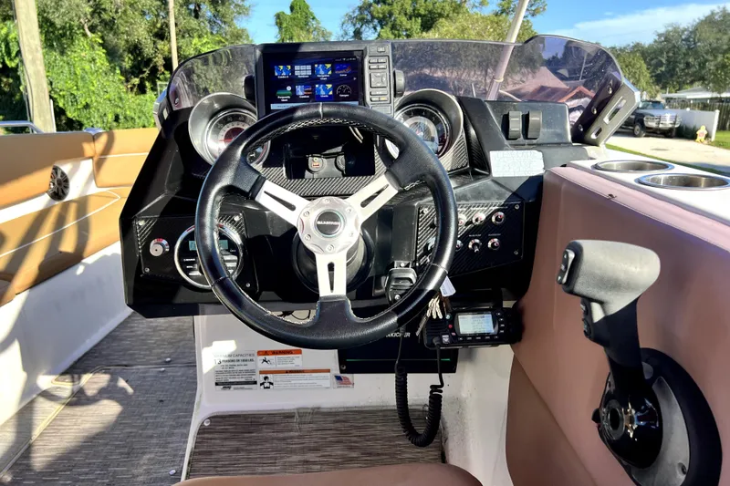 Slide: The Image of 2019 Glastron GTD 220 boat dashboard with steering wheel and control panel. - 29