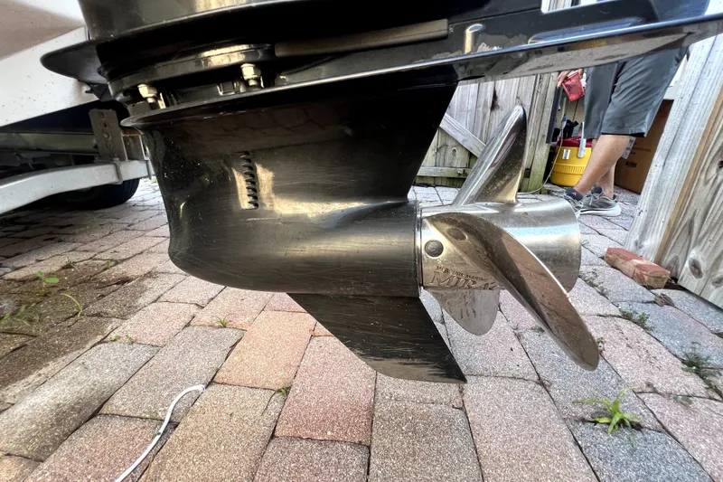 Slide: The Image of 2019 Glastron GTD 220 boat propeller on brick pavement, close-up view. - 16