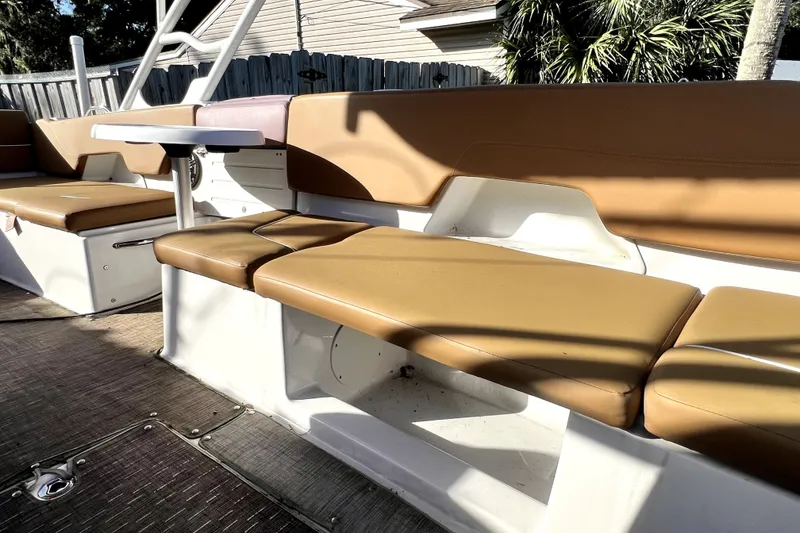 Slide: The Image of 2019 Glastron GTD 220 boat interior with tan seating and a small table. - 54