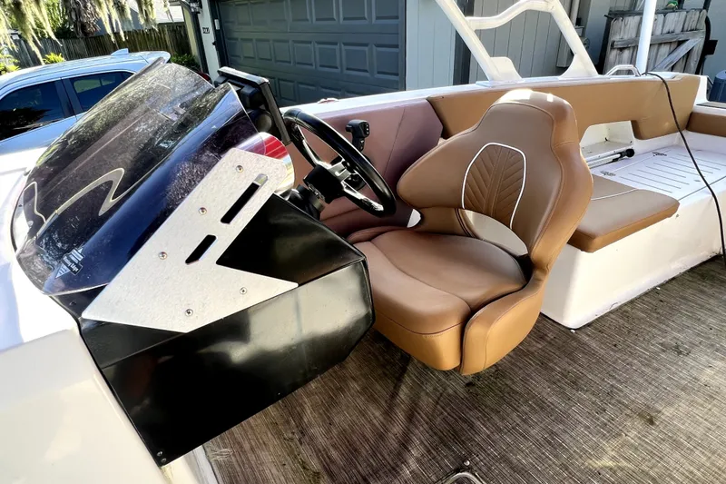 Slide: The Image of 2019 Glastron GTD 220 boat interior with tan seating and steering console. - 41