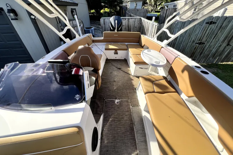 Slide: The Image of 2019 Glastron GTD 220 boat interior with tan seating and a small table. - 36
