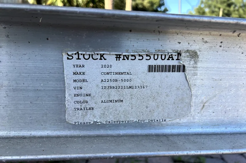 Slide: The Image of Label on aluminum trailer with stock number, year, make, model, and VIN details. - 74
