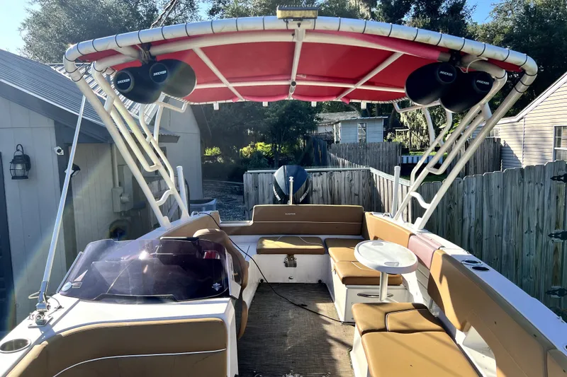 Slide: The Image of 2019 Glastron GTD 220 boat with red canopy and spacious seating area. - 48
