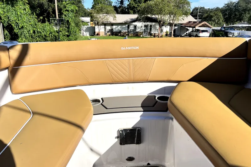 Slide: The Image of 2019 Glastron GTD 220 boat interior with tan seating and cup holders. - 60