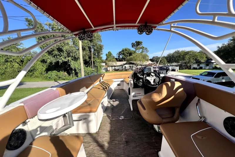 Slide: The Image of 2019 Glastron GTD 220 boat interior with red canopy and tan seating. - 27