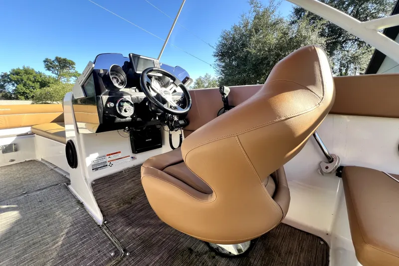Slide: The Image of 2019 Glastron GTD 220 boat interior with tan seating and modern dashboard. - 42