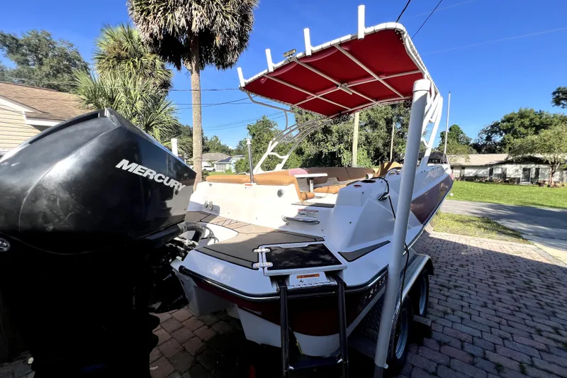 Slide: The Image of 2019 Glastron GTD 220 boat with Mercury engine, parked on a brick driveway. - 20
