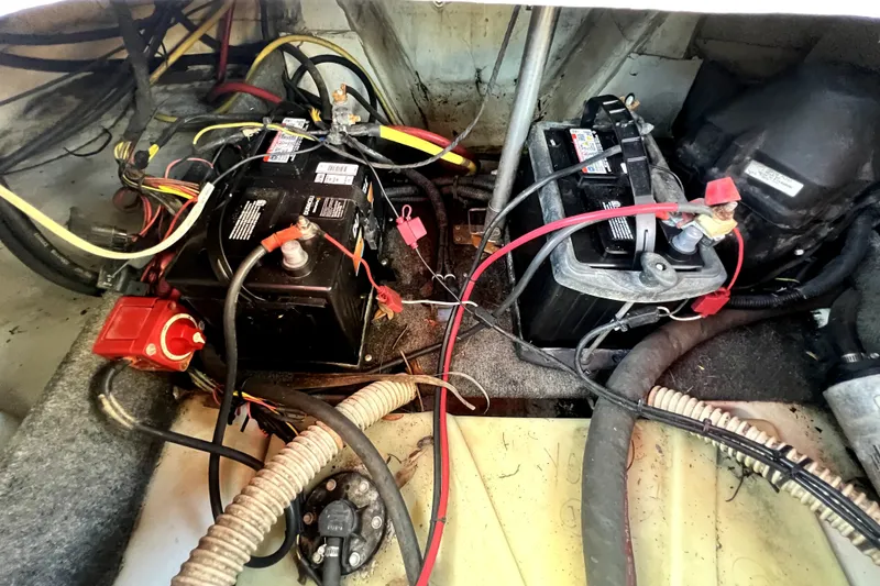 Slide: The Image of 2019 Glastron GTD 220 boat battery compartment with wiring and connections. - 70