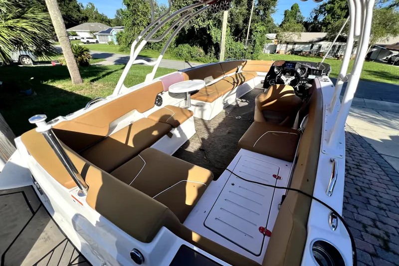 Slide: The Image of 2019 Glastron GTD 220 boat interior with tan seating and steering console. - 61