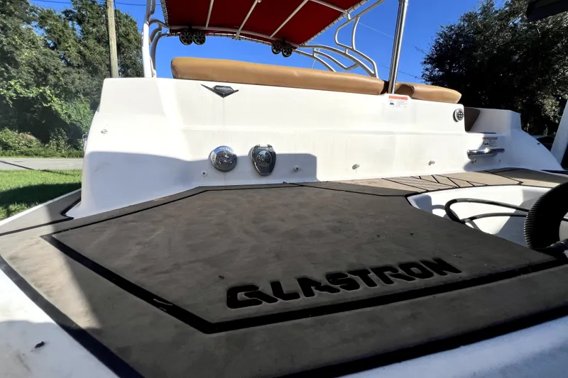 Slide: The Image of 2019 Glastron GTD 220 boat with red canopy and spacious deck. - 67