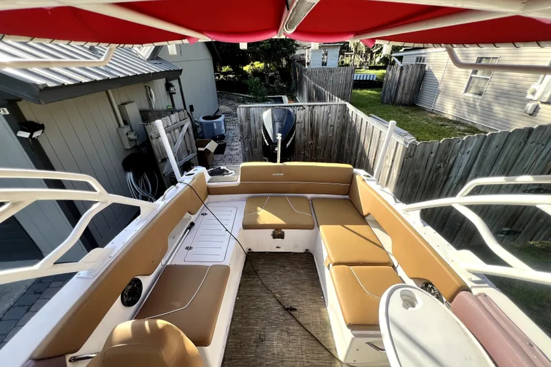 Slide: The Image of 2019 Glastron GTD 220 boat interior with tan seating and red canopy. - 49