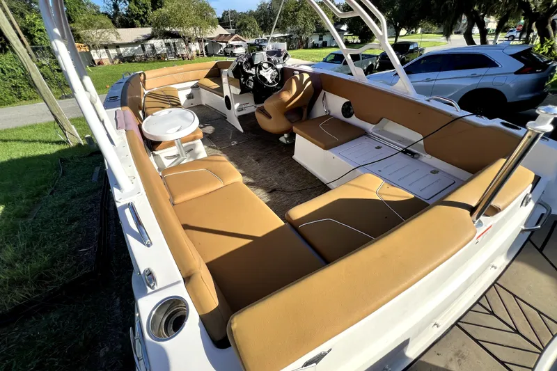 Slide: The Image of 2019 Glastron GTD 220 boat interior with tan seating and steering console. - 63