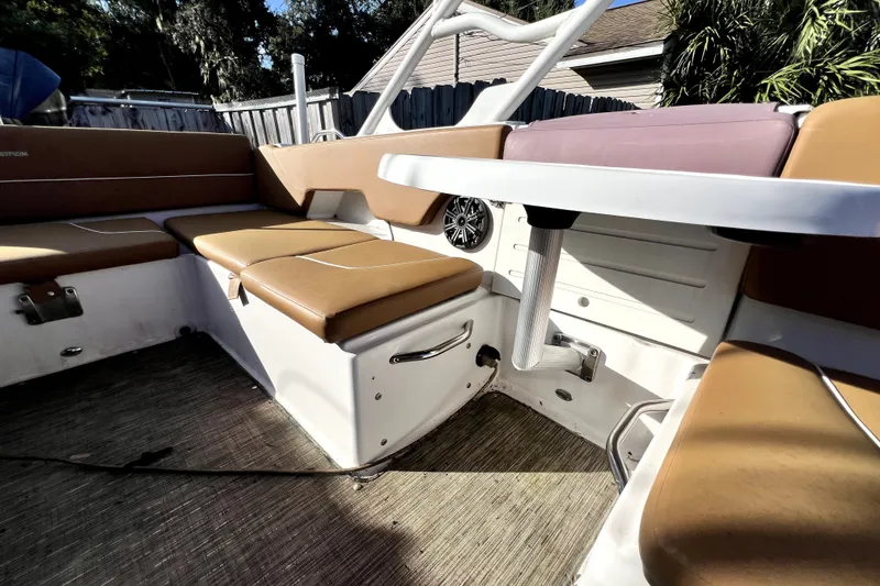 Slide: The Image of 2019 Glastron GTD 220 boat interior with tan seating and white table. - 39