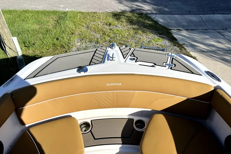 Slide: The Image of 2019 Glastron GTD 220 boat interior with tan seating and deck details. - 52