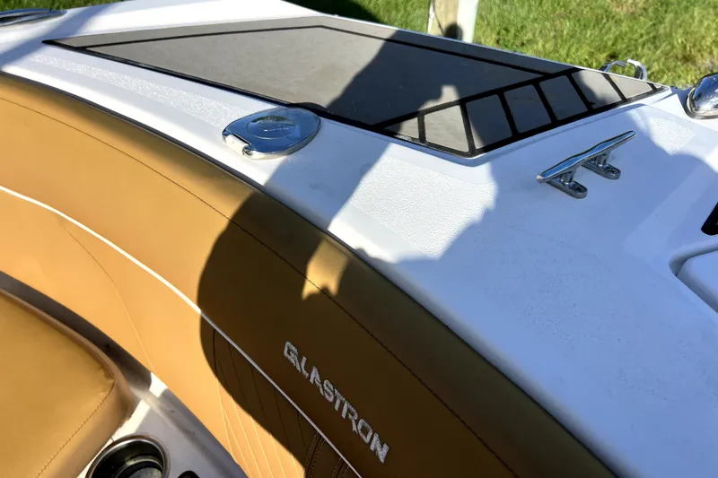 Slide: The Image of 2019 Glastron GTD 220 boat interior with tan upholstery and sleek design. - 44