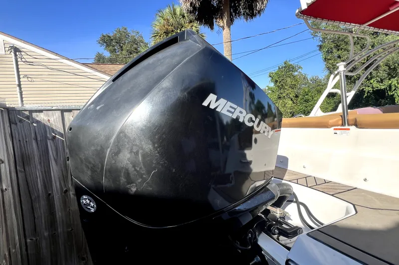 Slide: The Image of 2019 Glastron GTD 220 boat with Mercury outboard motor in a sunny outdoor setting. - 21