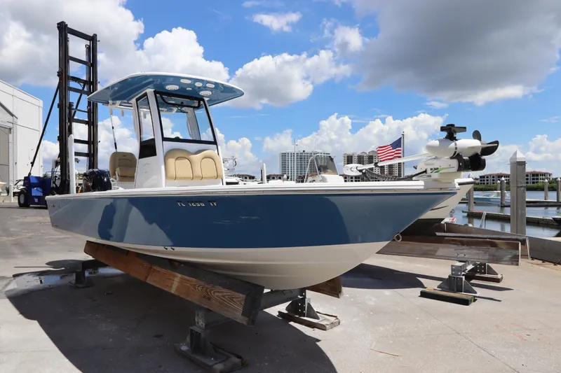 Slide: The Image of 2022 Sportsman Masters 247 Bay Boat docked under a bright blue sky. - 1