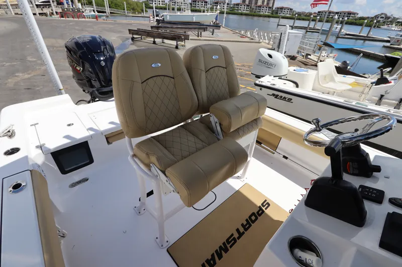Slide: The Image of 2022 Sportsman Masters 247 Bay Boat interior with dual seats and steering wheel. - 16