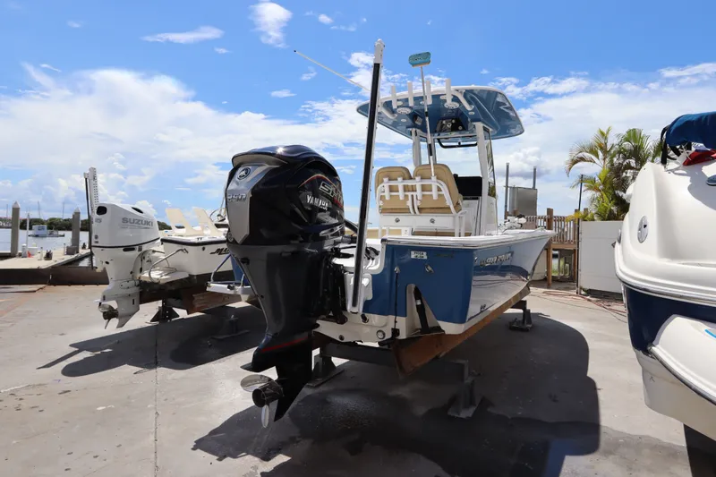 Slide: The Image of 2022 Sportsman Masters 247 Bay Boat with Yamaha engine, docked under a clear blue sky. - 3