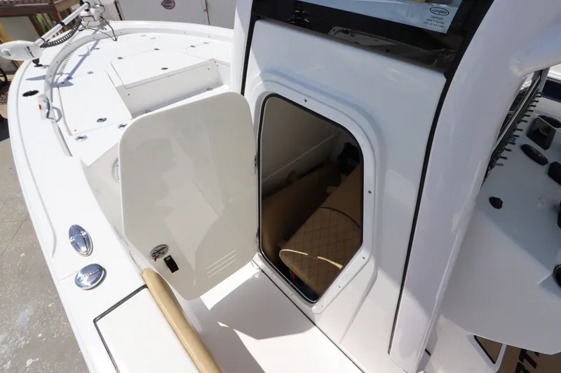 Slide: The Image of 2022 Sportsman Masters 247 Bay Boat interior view with open storage compartment. - 35