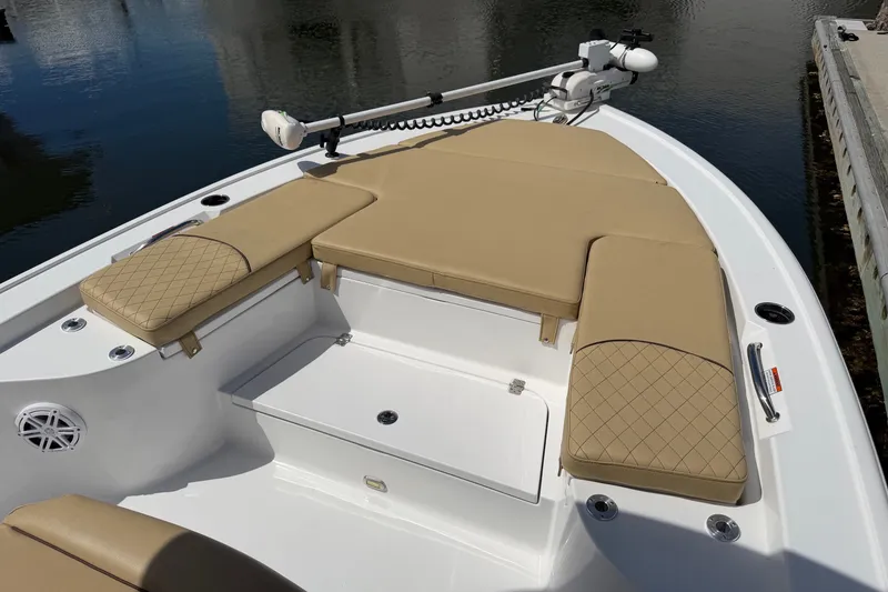 Slide: The Image of 2022 Sportsman Masters 247 Bay Boat with tan cushioned seating and storage compartments. - 24