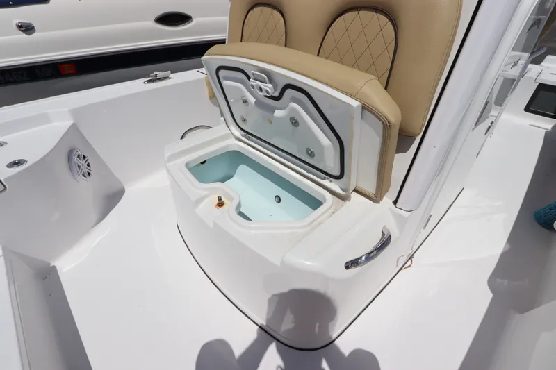 Slide: The Image of 2022 Sportsman Masters 247 Bay Boat with open storage compartment and cushioned seating. - 31