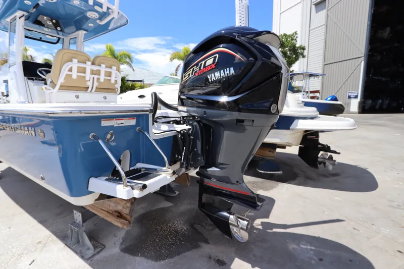 Slide: The Image of 2022 Sportsman Masters 247 Bay Boat with Yamaha outboard motor in a marina setting. - 7